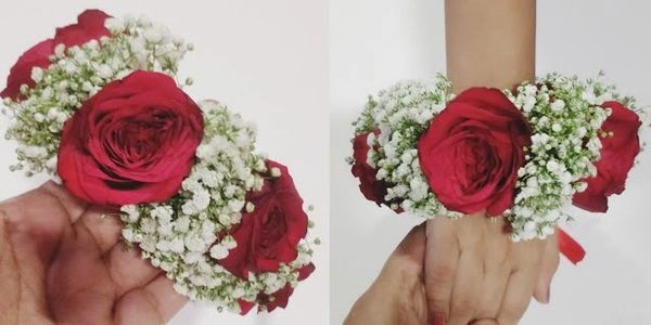 Red rose and white baby's breath flower wrist corsage.