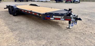 Flatbed trailer on dirt ground.