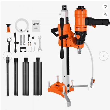 Orange and black core drilling machine with accessories.