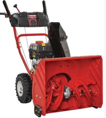 Red snow blower with black engine and wheels.