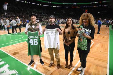 PemSpa Newton management team featured on court at Boston Celtics game, holding a branded jersey.