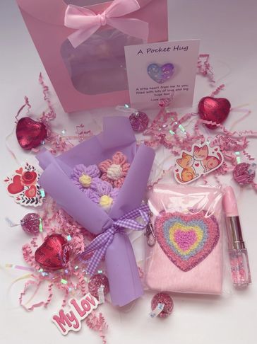 A charming pink and purple gift set with hearts, flowers, and cute decorations.