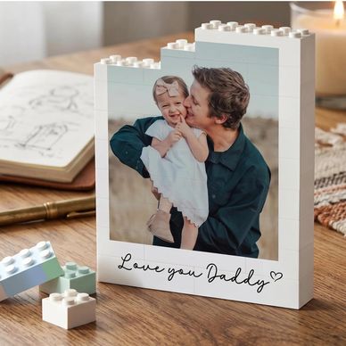 A custom LEGO photo frame with a father kissing his smiling child.