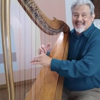 Reuben Correa playing a harp