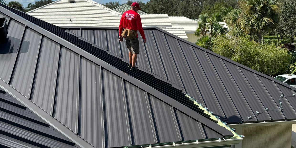 Lighting tech repairs roofline display in Lakewood Ranch. Sarasota crew serviced Wellen Park.