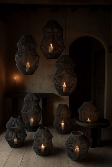 Dimly lit room with candles in woven lanterns creating a warm, cozy ambiance.