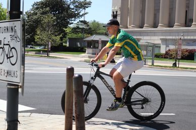 Bicyclist turning onto Pennsylvania Avenue Bike Lane from 7th Street, NW, WDC 27 April 2021