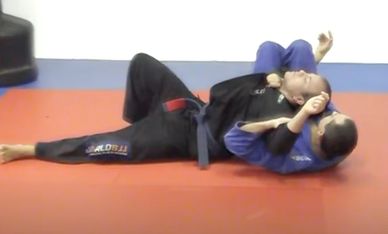 Two martial artists practicing Brazilian Jiu-Jitsu on a mat.