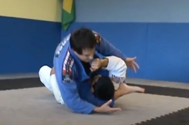 Two individuals practicing Brazilian Jiu-Jitsu on mats.