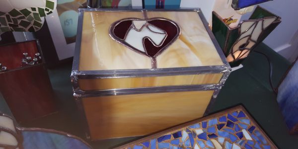 Glass "shoe box" with a stylized Wheaten Terrier profile in a heart, centered on top. 