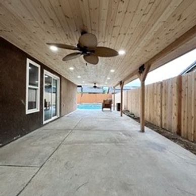 Wood patio with lighting and fan. 