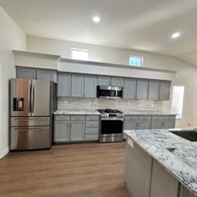 Kitchen remodel with new cabinets, backsplash, countertops, flooring and paint. 