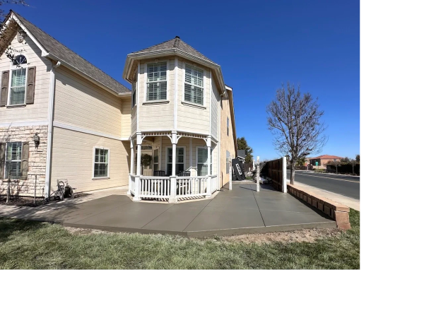 Front of house broomed concrete pad and side walkway. 