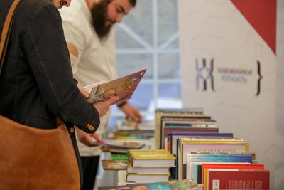 People browsing books at a book fair or bookstore.