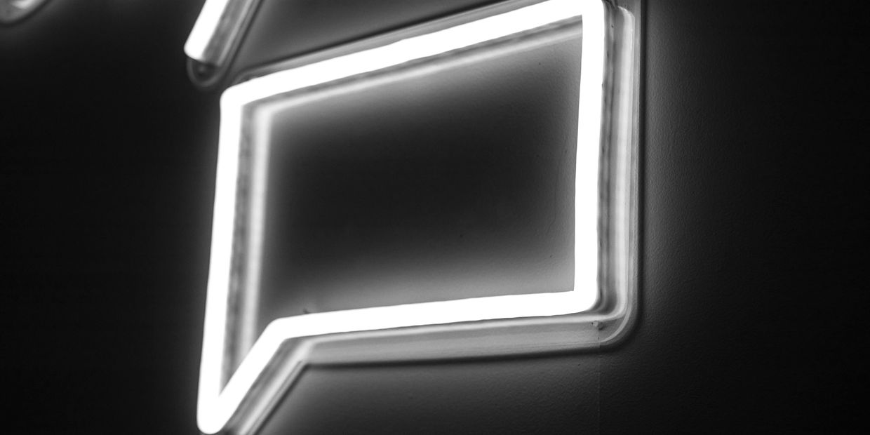 Photo of a neon speech bubble by Jason Leung on Unsplash