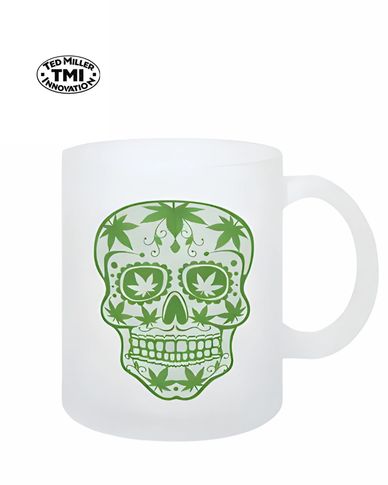 Frosted white mug with green skull and cannabis leaf design.