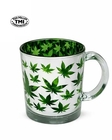 Clear glass mug decorated with green cannabis leaves inside and out.