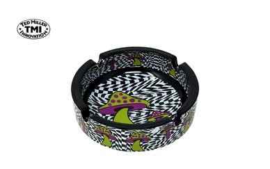 Colorful ashtray with psychedelic mushroom design and black-and-white swirl pattern.