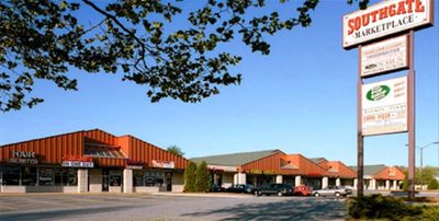 Tree branches and Southgate Marketplace pylon featuring retail and office tenants in Glen Burnie, MD