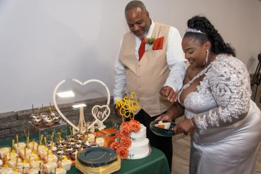 Bride and groom cutting their wedding cake.