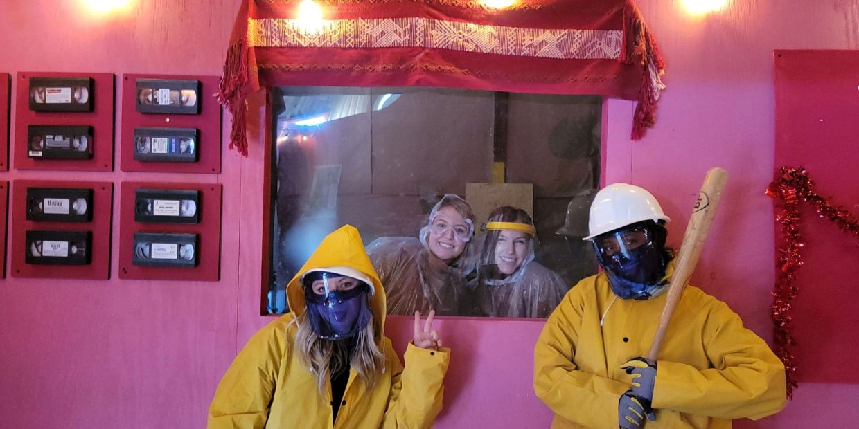 Group wearing protective gear in a room with pink walls.