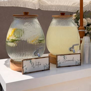 Self-serve dispensers displayed on the bar for water and lemonade