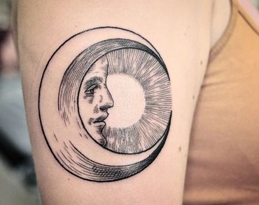 Etching tattoo of the moon man. tattooed by fine line expert, wade johnston.