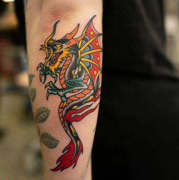 Trad dragon tattoo by experienced traditional tattoo artist, Wade Johnston