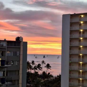 Waikiki sunset ocean view  with palm trees and sailboats over the Pacific in Honolulu, Hawaii