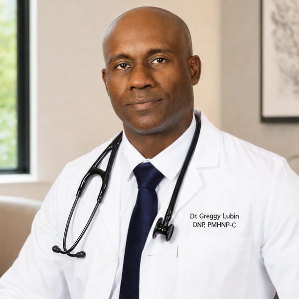 Dr. Greggy Lubin in a white medical coat with a stethoscope for a professional biography profile.