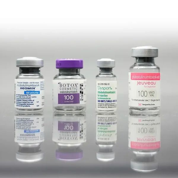 Four cosmetic botulinum toxin vials lined up.