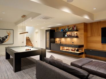 custom matte black natural oak media room theater bar cabinets liquor open shelves wall paneling 