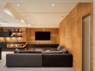 custom matte black natural oak media room theater bar cabinets liquor open shelves wall paneling 