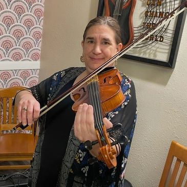 Woman playing a violin indoors.