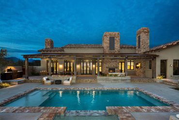 Modern house with a swimming pool at dusk.