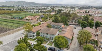 Aerial view of a suburban neighborhood with houses and farmland.