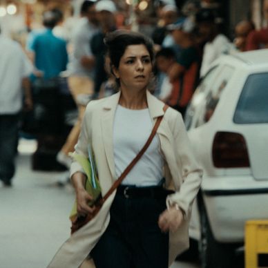 Woman walking purposefully in a busy street.