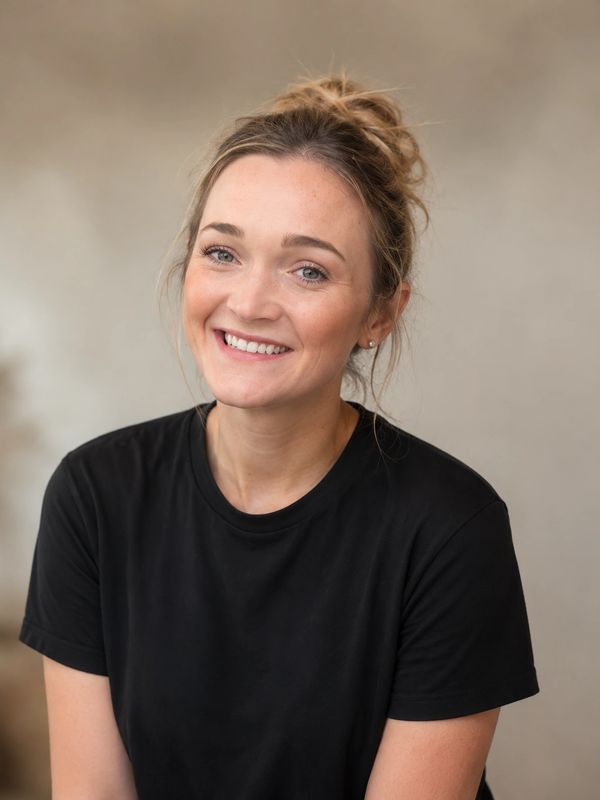 Smiling woman with blonde hair in a black t-shirt.