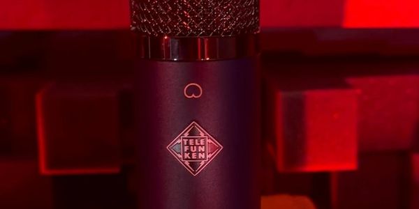 Close-up of a Telefunken microphone with red lighting.