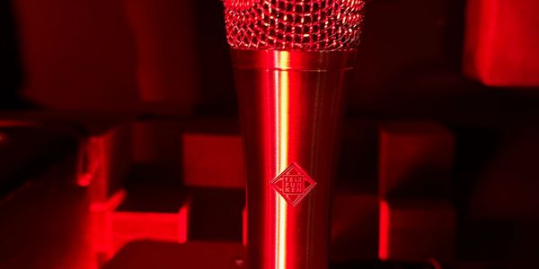 Close-up of a red microphone with a red light.