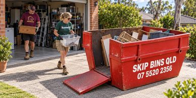 Illustrative garage clean-out: parents in workwear loading a red skip through its lowered door.