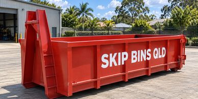 Representative red RORO hooklift bin in a sunny Queensland-style industrial setting.