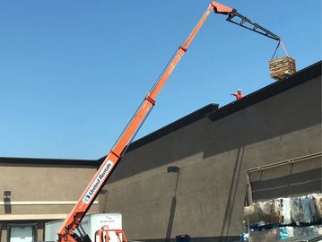 Crane lifting materials during solar panel repowering and recycling.