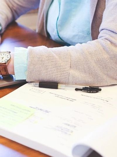 A person performing Christian book editing on a laptop.
