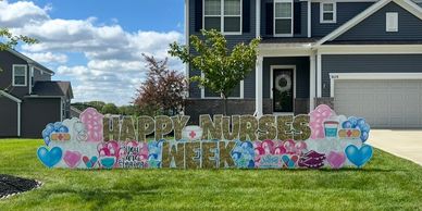 Colorful yard sign celebrating Nurses Week with hearts and medical symbols.