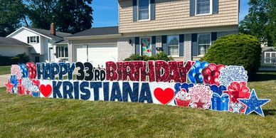 Large colorful yard sign wishing Kristiana a happy 33rd birthday.