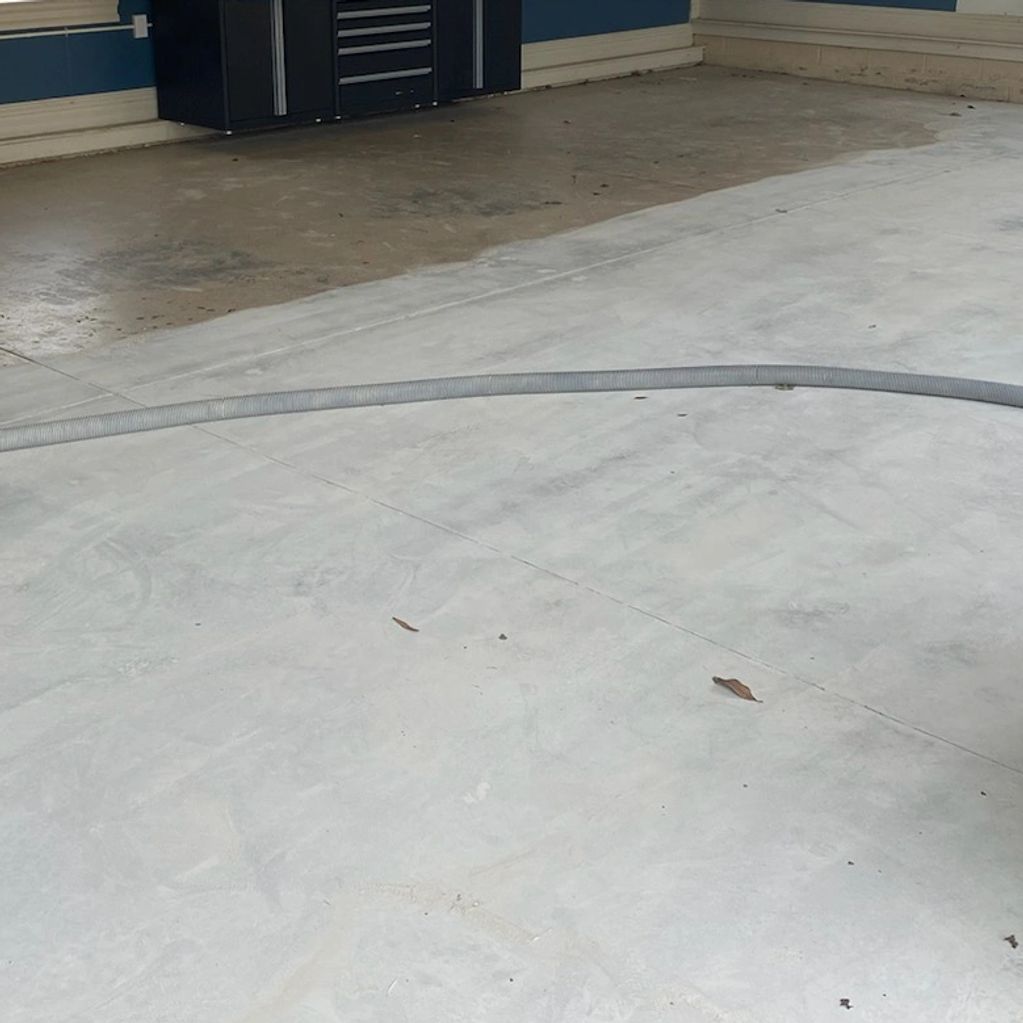 Garage floor surface prepared for epoxy coating, with professional vacuum equipment .