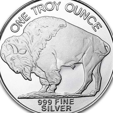 A silver coin featuring a buffalo and inscriptions about its weight and purity.