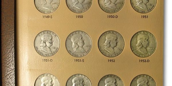 Collection of vintage coins arranged by year.