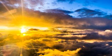 Sunset above the clouds with vibrant colors.